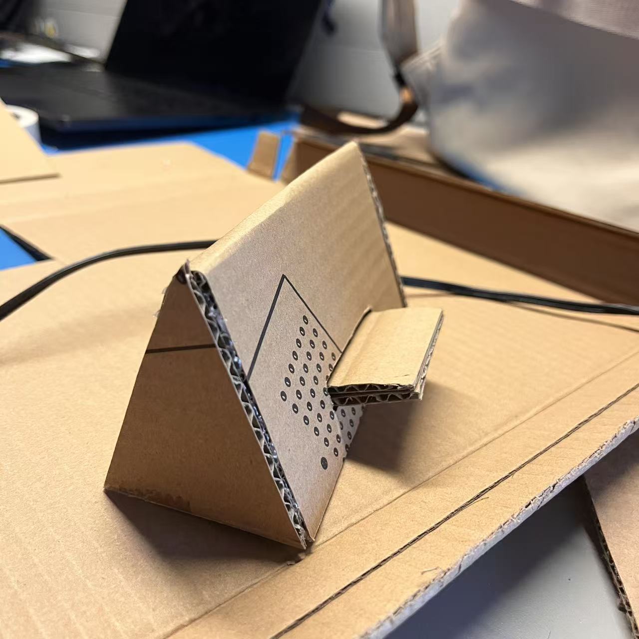 Testing the first angled stand shape and checking if it holds the phone steadily.