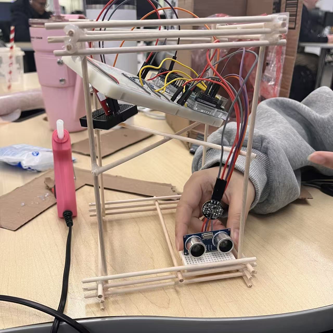 Placing the Arduino, breadboard, and sensors inside the frame to check wire paths and component angles.